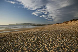 Footprints in the sand, beach and clouds in the evening light, in Figueira da Foz Footprints in the sand, beach and clouds in the evening light, in Figueira da Foz