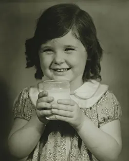 Girl (4-5) holding glass of milk, (B&W), portrait Girl (4-5) holding glass of milk, (B&W), portrait