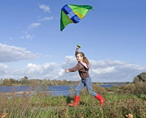 Girl flying a kite, kiteflying, Hitzacker, Lower Saxony, Germany, Europe Girl flying a kite, kiteflying, Hitzacker, Lower Saxony, Germany, Europe