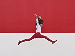 <b class=qtipBold><figcaption>Girl jumping in air at red wall</figcaption></b><br>Girl in high jump, dressed in red and white, at white and red wall.<br><em>© Copyright. Santiago bañón. 2012</em> Girl jumping in air at red wall