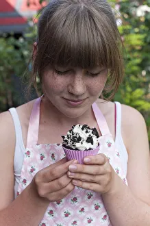 Girl looking at a homemade Oreo brownie cupcake Girl looking at a homemade Oreo brownie cupcake