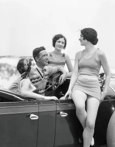 Vintage Swimwear Models Prints: Man at steering wheel of convertible car