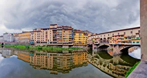 <b class=qtipBold><figcaption>Gloomy reflections</figcaption></b><br>Panoramic image of old city of Florence and Ponte Vecchio reflected by Arno River.<br><em>© Jon and Tina Reid</em> Gloomy reflections