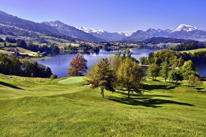 Golf course on the Lake of Gruyere or Lac de la Gruyere Golf course on the Lake of Gruyere or Lac de la Gruyere