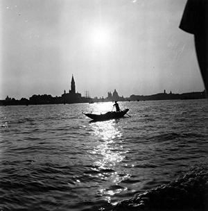 Grand Canal; lone gondolier silhouetted against the dawn as it breaks over the Grand Grand Canal; lone gondolier silhouetted against the dawn as it breaks over the Grand