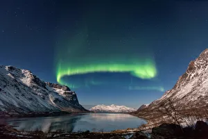 <b class=qtipBold><figcaption>Green Crown</figcaption></b><br>Northern Lights (Aurora Borealis) over GrotfjAžrd, KvalAžya (lit. Whale Island).KvalAžya is a montainous island located in Troms county in northern Norway.Moonlit, snowcapped mountains reflected in the water.<br><em>© 2015 Krzysztof Baranowski</em> Green Crown