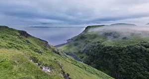 Green hills near the ocean on Isle of Skye in mist - Isle of Skye Scotland Green hills near the ocean on Isle of Skye in mist - Isle of Skye Scotland