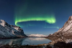 <b class=qtipBold><figcaption>Green Snake</figcaption></b><br>Northern Lights (Aurora Borealis) over GrotfjAžrd, KvalAžya (lit. Whale Island).KvalAžya is a montainous island located in Troms county in northern Norway.Moonlit, snowcapped mountains reflected in the water.<br><em>© 2015 Krzysztof Baranowski</em> Green Snake
