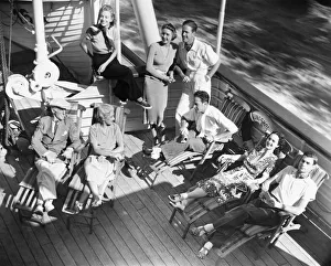 Group of people relaxing on cruiser deck (B&W), elevated view Group of people relaxing on cruiser deck (B&W), elevated view