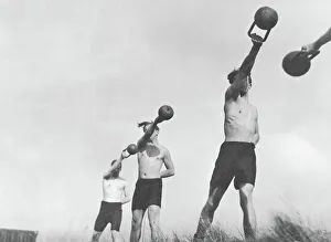 Group of young men exercising outdoors with weights (B&W) Group of young men exercising outdoors with weights (B&W)