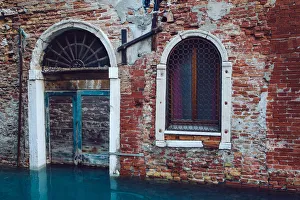 Half sunken door of townouse by the canal in Venice, Italy Half sunken door of townouse by the canal in Venice, Italy