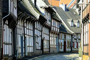 Half timbered houses and cobbled street in the historic old town of Goslar, Germany Half timbered houses and cobbled street in the historic old town of Goslar, Germany