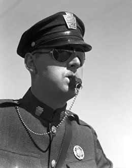 Highway Patrolman In Uniform And Sunglasses Blowing His Whistle Without Use Of His Hands Highway Patrolman In Uniform And Sunglasses Blowing His Whistle Without Use Of His Hands