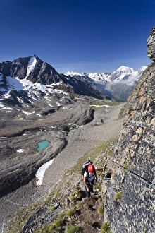 Hiker ascending Mt Tschenglser Hochwand or Croda di Cengles over the via ferrata Hiker ascending Mt Tschenglser Hochwand or Croda di Cengles over the via ferrata