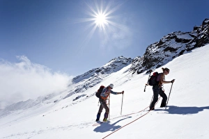Hikers on Weissbrunnferner Mountain during the ascent to Hinterer Eggenspitz Mountain in the Val dUltimo Hikers on Weissbrunnferner Mountain during the ascent to Hinterer Eggenspitz Mountain in the Val dUltimo