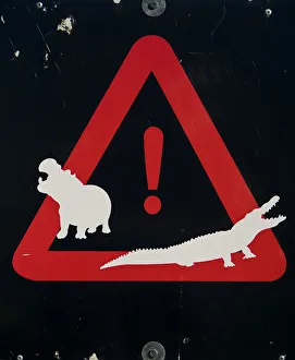 Hippopotamus and crocodile warning sign, St Lucia Estuary, KwaZulu-Natal Province Hippopotamus and crocodile warning sign, St Lucia Estuary, KwaZulu-Natal Province