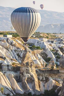Hot air balloon flying over rock landscape at Cappadocia Turkey Hot air balloon flying over rock landscape at Cappadocia Turkey