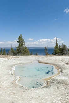 Hot spring, clear water, Perforated Pool, West Thumb, Yellowstone Lake in the background Hot spring, clear water, Perforated Pool, West Thumb, Yellowstone Lake in the background