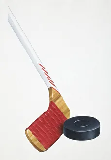 Ice hockey stick striking rubber disc, close up Ice hockey stick striking rubber disc, close up