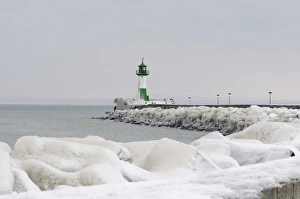 Iced wharf and a lighthouse in the port of Sassnitz on Ruegen Island, Mecklenburg-Western Iced wharf and a lighthouse in the port of Sassnitz on Ruegen Island, Mecklenburg-Western