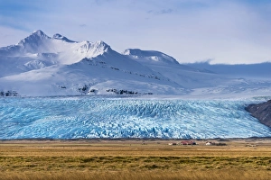 Icelandic farmstead with glacier tongue and snow-covered mountains, Hofn, Iceland Icelandic farmstead with glacier tongue and snow-covered mountains, Hofn, Iceland