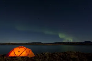 Illuminated expedition tent, Northern lights, Polar Aurorae, Aurora Borealis, green Illuminated expedition tent, Northern lights, Polar Aurorae, Aurora Borealis, green
