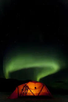 Illuminated expedition tent and traditional wooden snow shoes, Northern or Polar Lights Illuminated expedition tent and traditional wooden snow shoes, Northern or Polar Lights