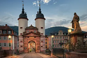 Illuminated Old Bridge Gate at Karl Theodor Bridge in Heidelberg, Baden-Wurttemberg Illuminated Old Bridge Gate at Karl Theodor Bridge in Heidelberg, Baden-Wurttemberg