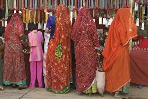 Images Dated 23rd November 2004: India, Rajasthan, Pushkar, women and girl shopping, rear view