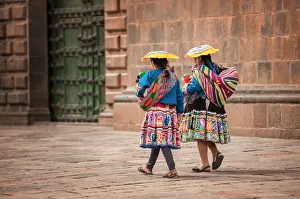 Two indigenous women walking in the city square of Cusco, Peru Two indigenous women walking in the city square of Cusco, Peru