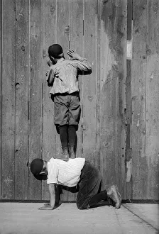 <b class=qtipBold><figcaption>Ingenious Fans</figcaption></b><br>One boy climbs onto the back of another to get a free view of a baseball game, circa 1935. (Photo by FPG/Hulton Archive/Getty Images)<br><em>© 2004 Getty Images</em> Ingenious Fans