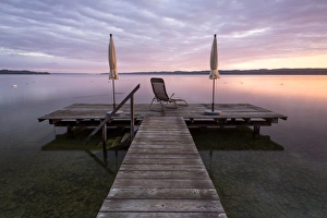 Jetty, early morning at the autumnal Lake Starnberg near Seeshaupt, Bavaria, Germany Jetty, early morning at the autumnal Lake Starnberg near Seeshaupt, Bavaria, Germany