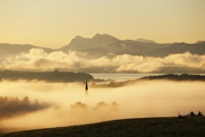 Lake Chiemsee and the church steeple of Greimharting as seen from Ratzinger Hoehe in the Lake Chiemsee and the church steeple of Greimharting as seen from Ratzinger Hoehe in the