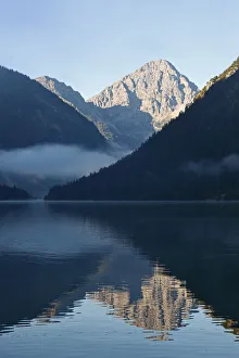 Lake Plansee and Ammergebirge mountains, in the back Mt. Thaneller in the Lechtal Alps Lake Plansee and Ammergebirge mountains, in the back Mt. Thaneller in the Lechtal Alps