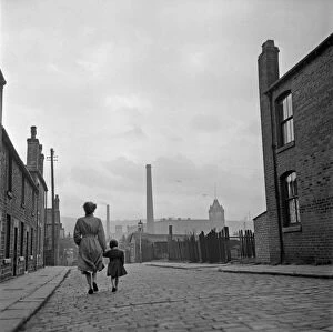 Lancashire Mill Town; Cotton mill worker Alice Nelson sets out for work at the Lilac Mill in Shaw