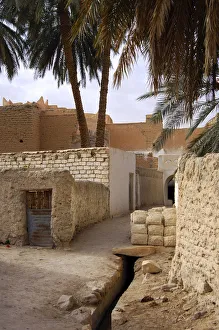 Lane with a pile of mud bricks in the backyards of the oasis of Ghadames, UNESCO world heritage Lane with a pile of mud bricks in the backyards of the oasis of Ghadames, UNESCO world heritage