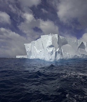 Large tabular iceberg and great cumulus clouds Large tabular iceberg and great cumulus clouds