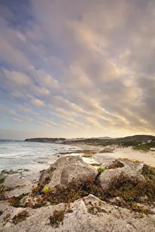 Late evening landscape of ocean over rocky shore with heavy clouds blowing in - Arniston Late evening landscape of ocean over rocky shore with heavy clouds blowing in - Arniston
