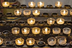 Lighted votive candles in a church, Munich, Upper Bavaria, Bavaria, Germany Lighted votive candles in a church, Munich, Upper Bavaria, Bavaria, Germany