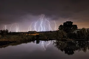 Lightning strikes over abandoned farm house and dam, Magaliesburg, Gauteng Province, South Africa Lightning strikes over abandoned farm house and dam, Magaliesburg, Gauteng Province, South Africa