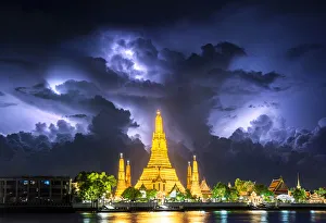 Lightning thunderstorm, rain, over Wat Arun, buddha temple famous landmark for travel by Lightning thunderstorm, rain, over Wat Arun, buddha temple famous landmark for travel by