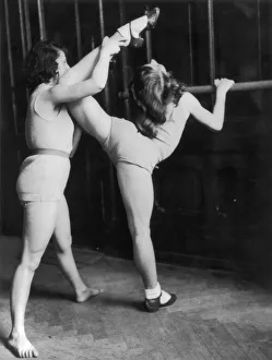 <b class=qtipBold><figcaption>Limbering Up</figcaption></b><br>Two women perform stretching exercises at the barre, circa 1930. (Photo by FPG/Hulton Archive/Getty Images)<br><em>© 2004 Getty Images</em> Limbering Up