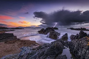 Llanddwyn Island beach at sunset with a lightning strike, Bangor, Caernarfon,, Anglesey Llanddwyn Island beach at sunset with a lightning strike, Bangor, Caernarfon,, Anglesey