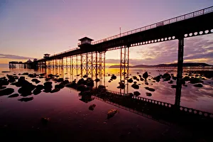 <b class=qtipBold><figcaption>Llandudno sunrise</figcaption></b><br>Llandudno Pier at low tide and sunrise with reflections in water of the pier and rocks North Wales.<br><em>© @ gail Johnson 2011</em> Llandudno sunrise