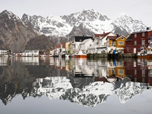 The Lofoten mountains being reflected in the water of the harbour of Henningsvaer, Lofoten, Norway The Lofoten mountains being reflected in the water of the harbour of Henningsvaer, Lofoten, Norway
