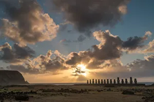 Lone monolithic giant stone Moai statue looking out to sea at Tongariki Lone monolithic giant stone Moai statue looking out to sea at Tongariki