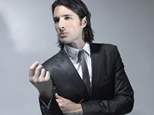 Long-haired man in his early thirties wearing a suit, fashion shoot Long-haired man in his early thirties wearing a suit, fashion shoot