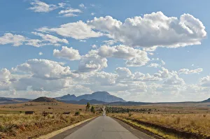 Toliara Gallery: Long straight road, vast arid landscape, sky with clouds, Isalo National Park near Ranohira