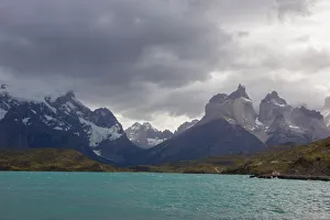 Looking across the cold waters of Lake Pehue to the snow-capped mountain peaks of Looking across the cold waters of Lake Pehue to the snow-capped mountain peaks of