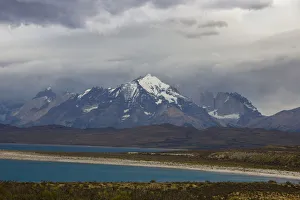 Looking across the turquoise waters of Lake Sarmiento to the snow-capped mountain peaks Looking across the turquoise waters of Lake Sarmiento to the snow-capped mountain peaks